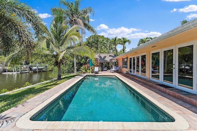 1256 Holly Cove Dr, Jupiter, FL 33458 - outdoor pool with a water view, a patio area, and french doors