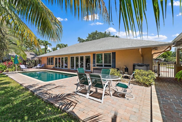 1256 Holly Cove Dr, Jupiter, FL 33458 - view of pool with a fenced in pool, fence, a jacuzzi, and a patio area