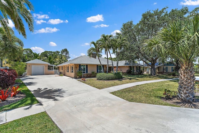 1256 Holly Cove Dr, Jupiter, FL 33458 - ranch-style home featuring a front lawn, stucco siding, driveway, and a detached garage