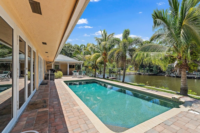 1256 Holly Cove Dr, Jupiter, FL 33458 - pool featuring a patio and a water view