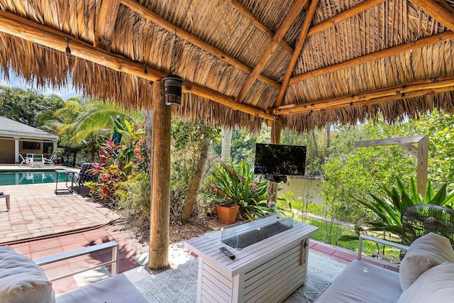 1256 Holly Cove Dr, Jupiter, FL 33458 - view of patio featuring a gazebo, an outdoor pool, and an outdoor fire pit