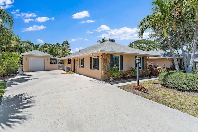 1256 Holly Cove Dr, Jupiter, FL 33458 - ranch-style house with central air condition unit, stucco siding, and concrete driveway
