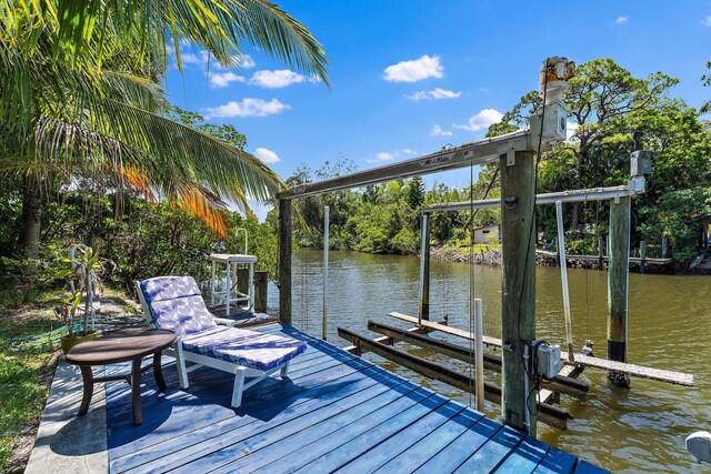1256 Holly Cove Dr, Jupiter, FL 33458 - view of dock featuring a water view and boat lift