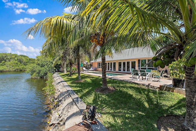 1256 Holly Cove Dr, Jupiter, FL 33458 - exterior space with a yard, a patio, a water view, and a swimming pool