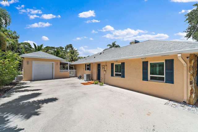 1256 Holly Cove Dr, Jupiter, FL 33458 - ranch-style house with central air condition unit, a garage, fence, and stucco siding