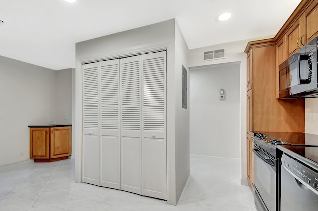 1341 NW 19 Th Ter Unit A, Delray Beach, FL 33445 - kitchen with black microwave, dishwasher, brown cabinets, recessed lighting, and dark countertops