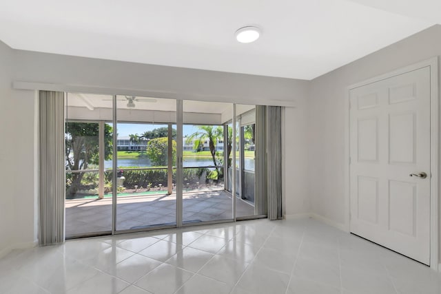1341 NW 19 Th Ter Unit A, Delray Beach, FL 33445 - spare room with a water view, ceiling fan, baseboards, and tile patterned floors