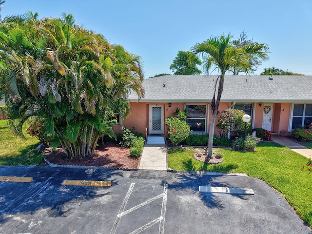 1341 NW 19 Th Ter Unit A, Delray Beach, FL 33445 - view of front of house with uncovered parking, stucco siding, and a front yard