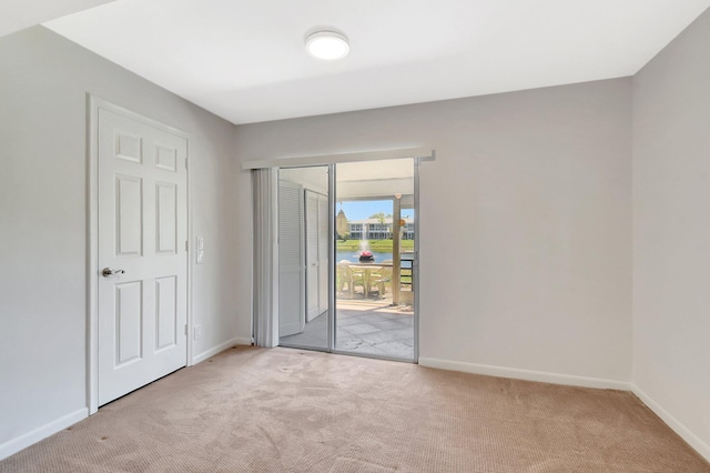 1341 NW 19 Th Ter Unit A, Delray Beach, FL 33445 - unfurnished bedroom with access to outside, light carpet, and baseboards