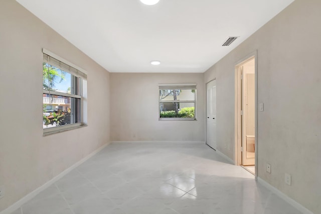 1341 NW 19 Th Ter Unit A, Delray Beach, FL 33445 - spare room with healthy amount of natural light, baseboards, and light tile patterned floors