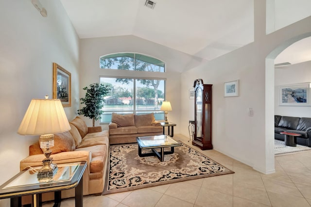 12249 Blair Ave, Boynton Beach, FL 33437 - living area with arched walkways, visible vents, light tile patterned floors, and vaulted ceiling