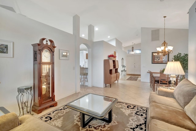 12249 Blair Ave, Boynton Beach, FL 33437 - living area featuring an inviting chandelier, arched walkways, high vaulted ceiling, light tile patterned floors, and visible vents