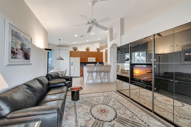 12249 Blair Ave, Boynton Beach, FL 33437 - living room featuring ceiling fan, arched walkways, high vaulted ceiling, recessed lighting, and light tile patterned floors
