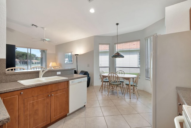 12249 Blair Ave, Boynton Beach, FL 33437 - kitchen featuring brown cabinets, light tile patterned flooring, ceiling fan, a sink, and white appliances