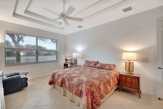 12249 Blair Ave, Boynton Beach, FL 33437 - bedroom with visible vents, light tile patterned floors, and a tray ceiling