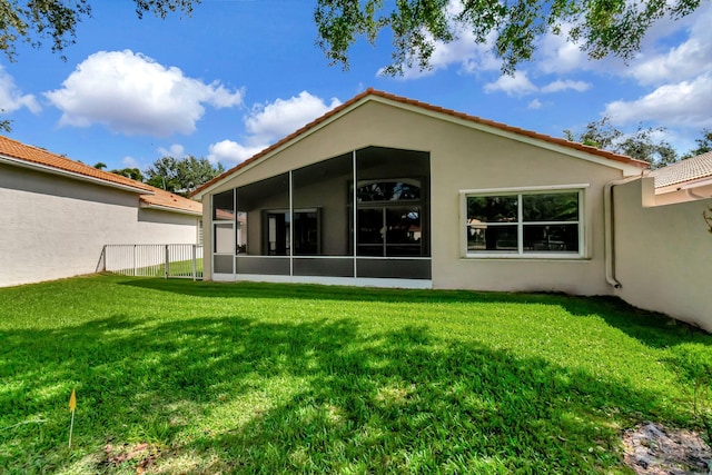 12249 Blair Ave, Boynton Beach, FL 33437 - back of property featuring a lawn, a tiled roof, a sunroom, and stucco siding