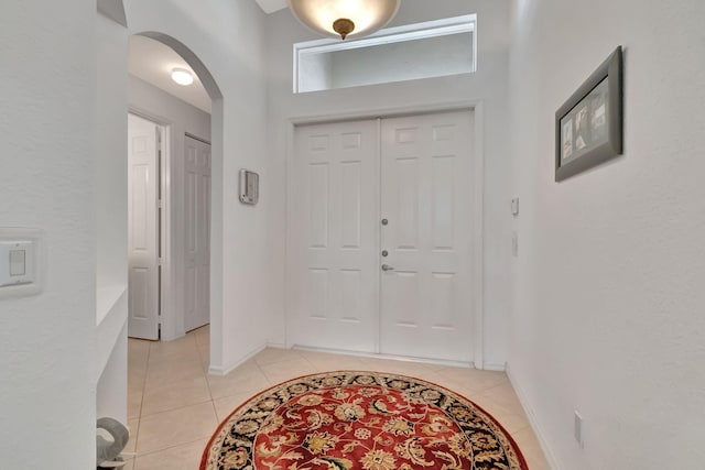 12249 Blair Ave, Boynton Beach, FL 33437 - foyer with light tile patterned floors, arched walkways, and baseboards