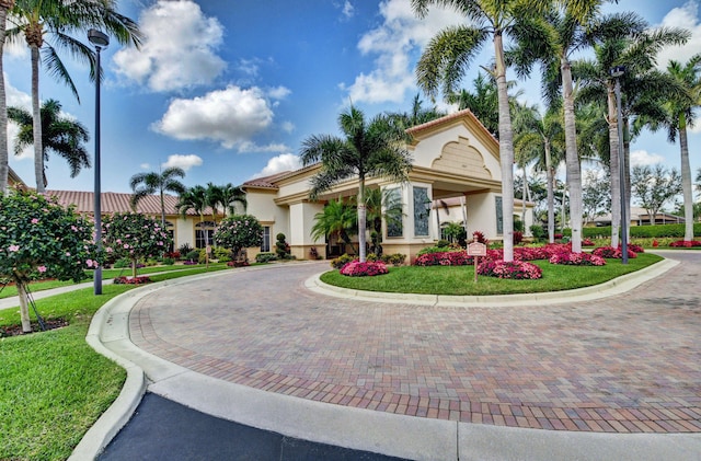 12249 Blair Ave, Boynton Beach, FL 33437 - exterior space with a tiled roof, curved driveway, a front lawn, and stucco siding