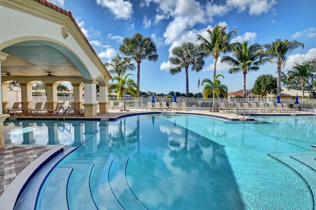 12249 Blair Ave, Boynton Beach, FL 33437 - pool with fence, ceiling fan, and a patio area