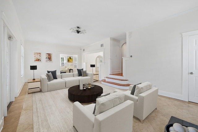 living area featuring arched walkways, baseboards, light tile patterned floors, and visible vents