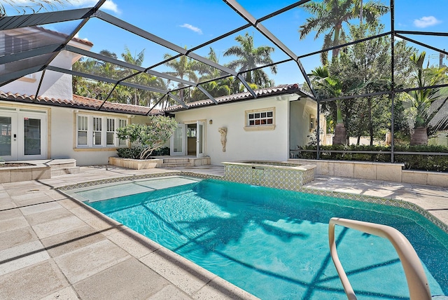 outdoor pool featuring an in-ground hot tub, a patio area, french doors, and glass enclosure