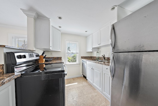 kitchen with appliances with stainless steel finishes, baseboards, white cabinetry, recessed lighting, and ornamental molding