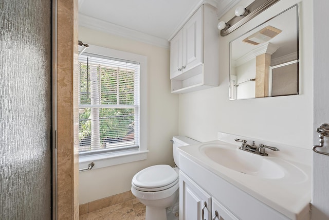 bathroom featuring crown molding, toilet, vanity, and a shower with shower door