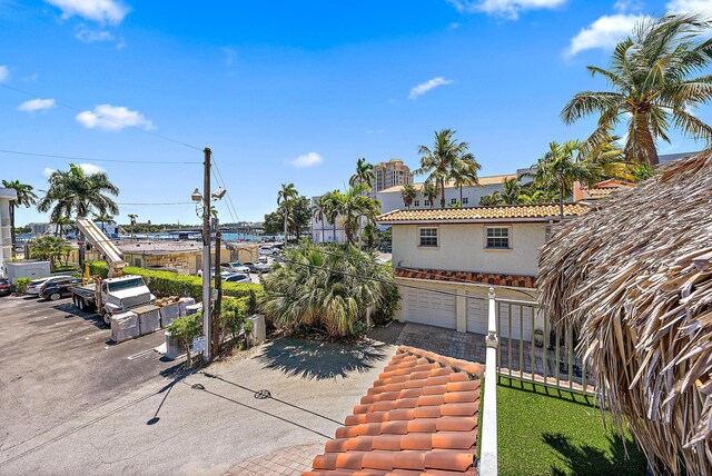view of patio / terrace with a garage, fence, and driveway