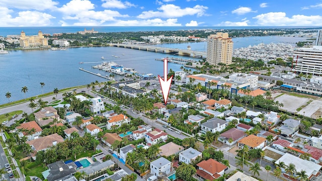 aerial view of property and surrounding area featuring a notable bridge, a nearby body of water, and nearby urban area