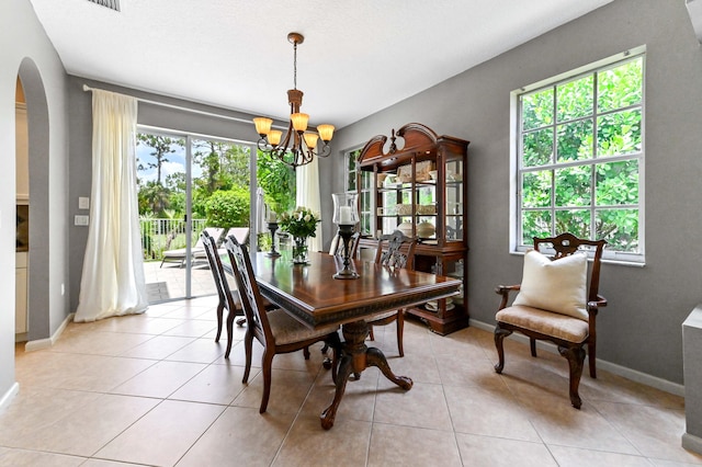 2256 Ridgewood Ct, Royal Palm Beach, FL 33411 - dining room featuring arched walkways, a chandelier, and light tile patterned floors