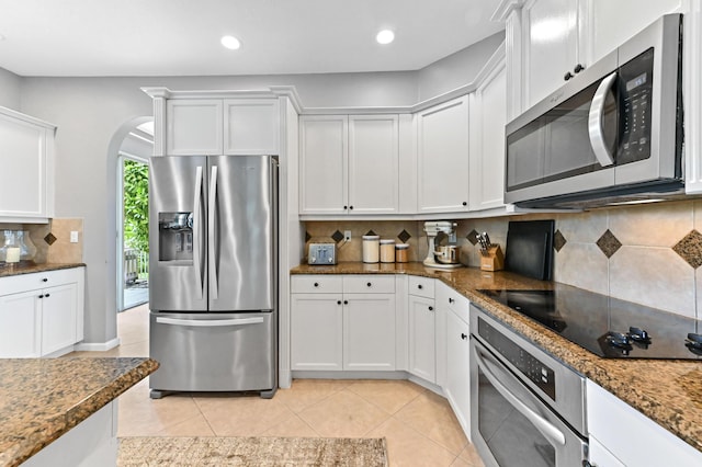 2256 Ridgewood Ct, Royal Palm Beach, FL 33411 - kitchen featuring appliances with stainless steel finishes, white cabinetry, tasteful backsplash, arched walkways, and recessed lighting
