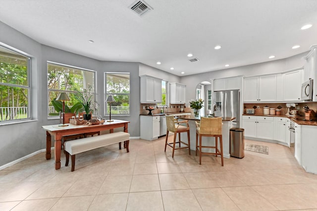 2256 Ridgewood Ct, Royal Palm Beach, FL 33411 - kitchen with appliances with stainless steel finishes, plenty of natural light, a center island, decorative backsplash, and recessed lighting