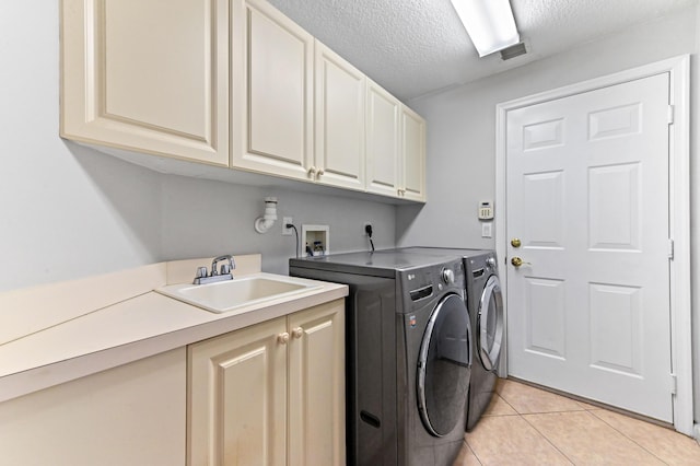 2256 Ridgewood Ct, Royal Palm Beach, FL 33411 - laundry room with cabinet space, washing machine and clothes dryer, light tile patterned floors, and a textured ceiling