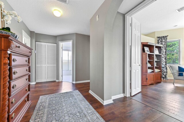 2256 Ridgewood Ct, Royal Palm Beach, FL 33411 - foyer featuring dark wood-type flooring, arched walkways, and a textured ceiling