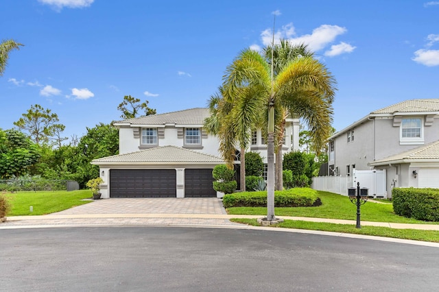 2256 Ridgewood Ct, Royal Palm Beach, FL 33411 - view of front of home with driveway, an attached garage, stucco siding, and a tile roof