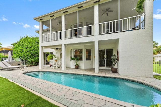 2256 Ridgewood Ct, Royal Palm Beach, FL 33411 - back of property with a ceiling fan, a balcony, a patio, stucco siding, and an outdoor pool