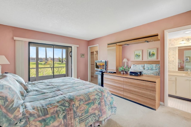 544 Piedmont L, Delray Beach, FL 33484 - bedroom featuring a sink, carpet, a textured ceiling, and connected bathroom