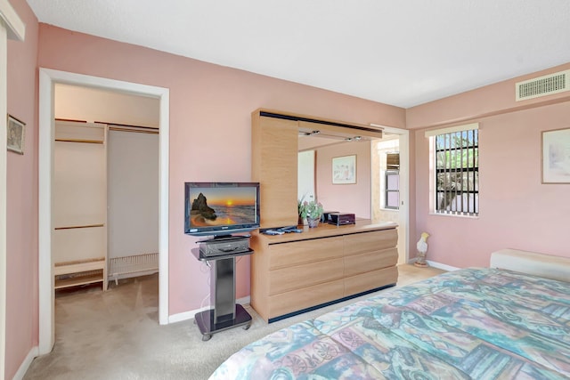 544 Piedmont L, Delray Beach, FL 33484 - bedroom with baseboards, visible vents, light carpet, and a spacious closet