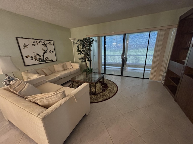living area featuring light tile patterned flooring and a textured ceiling