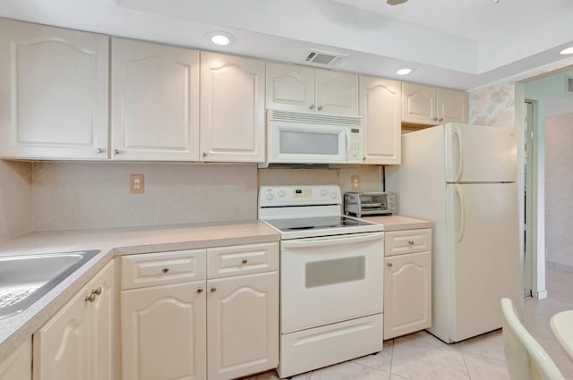 544 Piedmont L, Delray Beach, FL 33484 - kitchen with visible vents, a toaster, white appliances, light countertops, and light tile patterned floors