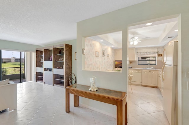 544 Piedmont L, Delray Beach, FL 33484 - corridor with a sink, recessed lighting, light tile patterned floors, a tray ceiling, and visible vents