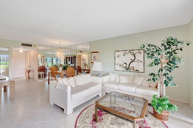 544 Piedmont L, Delray Beach, FL 33484 - living area with a chandelier, a textured ceiling, and visible vents