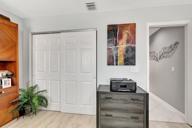 interior space featuring baseboards, visible vents, and a closet