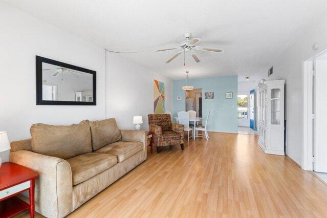 1118 Lake Ter Unit H209, Boynton Beach, FL 33426 - living room with a textured ceiling, a ceiling fan, and wood finished floors
