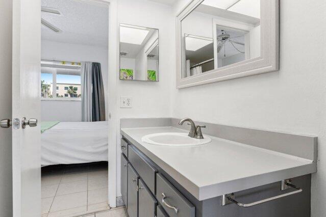 1118 Lake Ter Unit H209, Boynton Beach, FL 33426 - bathroom with visible vents, vanity, toilet, connected bathroom, and tile patterned floors