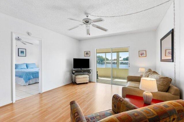 1118 Lake Ter Unit H209, Boynton Beach, FL 33426 - living area with ceiling fan, light wood-type flooring, and a textured ceiling