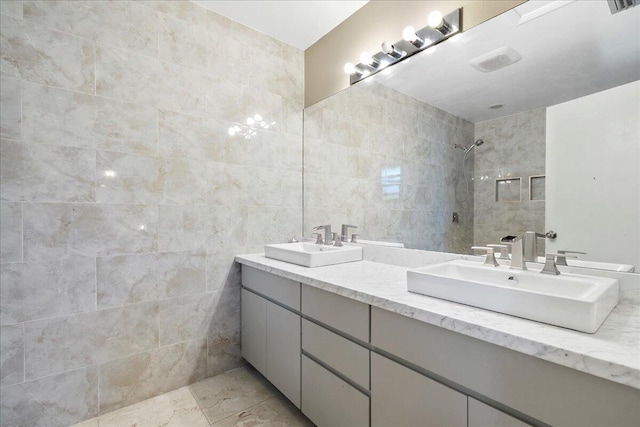 12610 63rd Ln N, The Acreage, FL 33412 - full bathroom with double vanity, tile walls, a tile shower, and a sink
