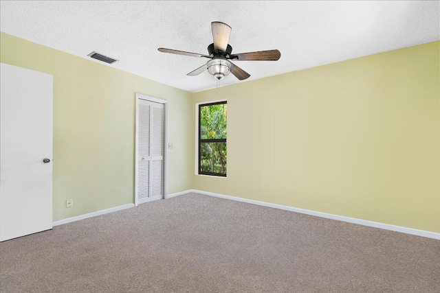 12610 63rd Ln N, The Acreage, FL 33412 - empty room with carpet flooring, a textured ceiling, a ceiling fan, baseboards, and visible vents