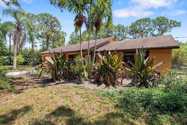 12610 63rd Ln N, The Acreage, FL 33412 - view of front of property featuring a shingled roof and stucco siding