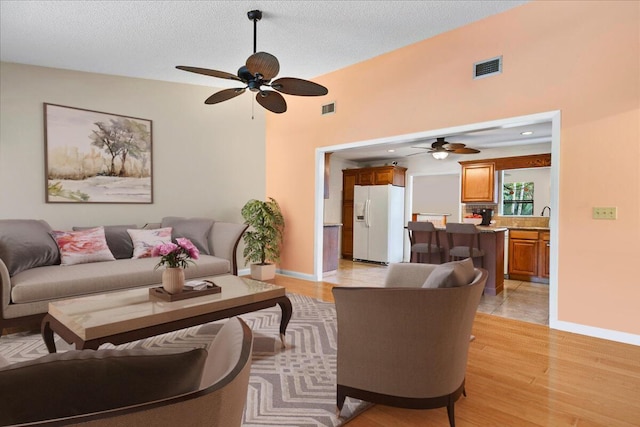12610 63rd Ln N, The Acreage, FL 33412 - living room featuring visible vents, a ceiling fan, and light wood-type flooring